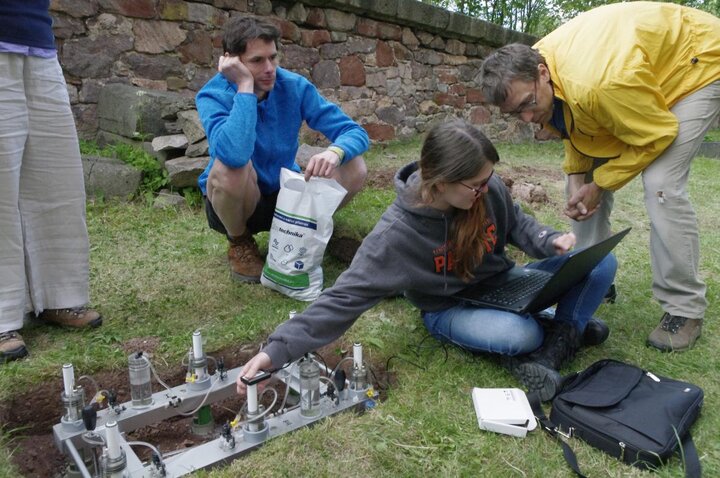 group working on equipment on ground